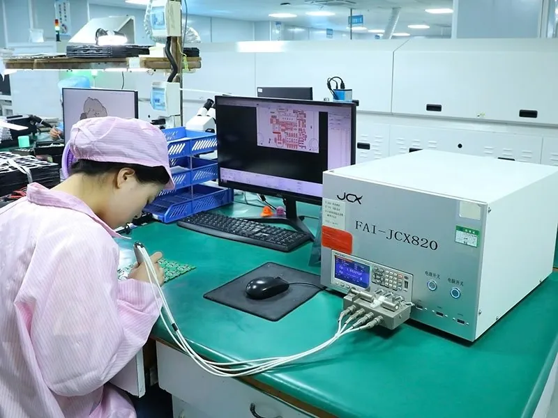 Engineer performing first article inspection on assembled circuit boards with measurement tools
